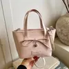 Bolso tipo cubo de moda de diseño minimalista de nicho estilo coreano transfronterizo, nuevo bolso de hombro y bandolera para mujer Primavera 2026