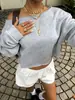 Sudadera corta de estilo europeo y americano para mujer, hombros descubiertos, color liso, hombros caídos, manga larga, holgada, hombro asimétrico, top corto casual para primavera y otoño