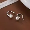 Pendientes de perla con gancho curvo de plata 925, estilo nuevo de nicho para mujeres jóvenes, pendientes de botón populares con un toque de alta gama, pendientes geométricos elegantes de diosa