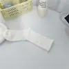 Meias brancas femininas outono e inverno meias de cano alto cor sólida japonesa meias de cano longo folgadas meias para o mês pós-parto de mulheres grávidas atacado