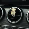 Aromaterapia para Coche Salida de Aire Acondicionado Decoraciones Decoración Perfume Suministros para el Interior del Coche Flores de Cinco Pétalos Cruz de Metal Transfronterizo