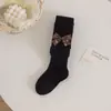 Leggings para niños 2026 primavera y otoño nuevo estilo pantimedias para niñas con rayas finas y lazo, calcetines para bebé de PP grande al por mayor