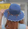 Chapéu de palha estilo étnico para mulheres, adequado para passeios de primavera e verão, chapéu de proteção solar com pingente de laço, chapéu de sol dobrável, transfronteiriço