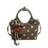 Exquisito bolso de mano de lunares de nicho estilo coreano para mujer, principios de otoño de 2026, bolso de hombro y cruzado Maillard de alta gama y elegante