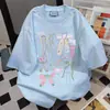 Camiseta linda con estampado de lazo estilo girly de manga corta para mujer 2025 Verano Nuevo Casual Holgado Estilo Universitario Top