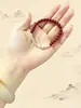 Pulsera de siete cuentas de arroz rojo con tres cuentas doradas y cuatro plateadas, nueva pulsera de estilo chino de lujo ligero para mujer, accesorio simple y versátil