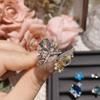 Anillo de camelia de quilates sobredimensionados imitación topacio azul flor brillante chapado en oro niña japonesa y coreana anillo de flor pequeña de epoxi