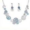 Diseño creativo de aleación de zinc geométrico redondo espiral color gota diseño hueco collar pendientes para damas traje
