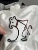 La textura es no más que diseño tridimensional cepillo de dientes bordado línea roja cuerda cachorro manga corta cuello redondo estilo casual camiseta 90% algodón damas