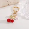 Amazon versión coreana de llavero con letras de cereza colgante accesorios para bolso aleación DIY cerezas colgantes venta al por mayor