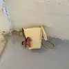 Exquisita mini bolsa de nicho con estampado de lichi para mujer, nueva moda 2026, bolso cruzado versátil, bolso cubo súper popular para teléfono