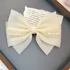 Clip de resorte con lazo de perla, accesorio para el cabello de alta gama, elegante y francés para celebridades de Internet.