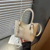 Bolso tejido de nicho de alta gama nuevo para primavera y verano, bolso cubo, bolso tipo empanada, bolso de axila simple y elegante de alta gama para mujer