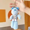 Bolsa mensageiro de celebridade da internet pingente de margarida ovelha branca pequena chaveiro de ovelha de pelúcia criativo pingente de bolsa atacado