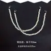 Vestido pequeño sin espalda estilo Chanel con accesorios de cadena de perlas, ropa tipo camisola, cadena colgante de tirante con cierre de langosta, decoración de escote en V