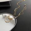 Versión coreana de un exquisito collar de acero de titanio con perlas apiladas de doble capa, venta al por mayor, diseño de alta gama sin decoloración para mujer, sentido de la cadena de clavícula de nicho