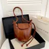 Bolso de calabaza de diseño nicho transfronterizo para mujer, bolso nuevo de diseño elegante, bolso tipo cubo, bolso de hombro cruzado retro individual