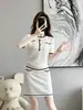 Estilo Socialité de Verano Bloques de Color Calado Adelgazante Top de Punto y Falda Set de Dos Piezas de Punto de Seda Helada para Mujer