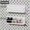 El tablero perforado de metal engrosado de IKEA se puede fijar magnéticamente a la pared, sirviendo como un estante de almacenamiento sin borde y se puede fijar magnéticamente