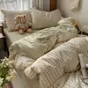 Nuevo modelo 2026 juego de ropa de cama de cuatro piezas de algodón lavado con diseño de jacquard teñido en hilo fresco y simple, adecuado para dormitorios de estudiantes y lavable a máquina