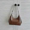 Bolso Cruzado de Hombro Único con Colgante Texturizado Color Sólido Casual Estilo Coreano Verano 2026 Nuevo Elegante Bolso Dumpling para Mujer