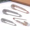 Artefacto de cintura ajustada Pantalones Falda Cintura Cambio grande Alfileres pequeños Ropa de mujer Cárdigan Suéter Hebilla anti-corrimiento Broche fijo