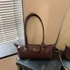 Bolso tipo baguette de lujo de nicho estilo francés, bolso tipo dumpling moderno y a la moda, adecuado para el uso diario, bolso versátil y moderno para hombro y debajo del brazo