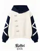 Sudadera con capucha de colorblock retro americano con botones de anillo metálico diagonales y diseño de tapeta irregular, directo del fabricante