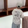 Camiseta de algodón puro para niño, colección primavera/otoño 2026, para bebés y niños pequeños, estampado de grafiti estilo coreano, camiseta interior de manga larga