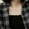 Moda simple pequeño fresco hueco colgante de amor collar para mujer versátil ins cadena de clavícula en forma de corazón alta calidad al por mayor
