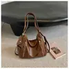 Bolsas pequeñas texturizadas estilo coreano al por mayor para mujer, nuevas y modernas 2026, bolsos de hombro lisos de color sólido, mochilas versátiles