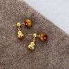 Pendientes vintage de otoño e invierno con hebilla de oreja de piedra de ojo de tigre de Maillard, de moda, ligeros, de lujo, de alta gama, 2024, nuevos y populares para mujer.