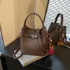 Bolso Cubo Versátil de Nicho Súper Popular Estilo Coreano 2026 Nuevo Bolso de Hombro Cruzado de Moda Casual para el Trabajo