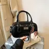 Bolsa Pequeña de Mano para Jugador de Bolos Transfronterizo para Mujer 2026 Nueva Versátil Textura Bolso de Hombro Único Bolso Cruzado Boston