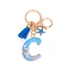 Llavero Colgante Temático Océano Azul con Borla de Estrella de Mar, Llavero de Resina Encanto para Bolso con 26 Letras