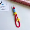 Pulseira criativa corda face sorridente chaveiro corda corda de celular japonesa anti-queda câmera celular celular feminino moderno corda trançada