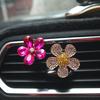 Clip de perfume para coche de camelia con incrustaciones de diamantes creativas transfronterizas, clip de fragancia de cristal para salida de aire acondicionado del coche