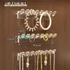 Estante de exhibición de joyas para montar en la pared detrás de la puerta del gabinete con espejo para guardar collares, anillos, pulseras y aretes para evitar que se enreden.