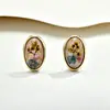 Nuevos pendientes de estilo chino de lujo ligero con flores secas de ámbar transparente con un toque de alta gama, pendientes de flor de resina ovalada con aguja de plata, versátiles y de moda para mujer