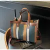 Bolsa de lona de gran capacidad para mujer, nuevo bolso de mano a rayas primavera 2026, bolsa grande para estudiantes universitarios, adecuado para la clase y el transporte diario, bolso cruzado