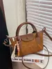 Bolsa de Dumpling Nueva de Otoño e Invierno Transfronteriza Bolsas de Dragón Bolso de Hombro Cruzado Retro Nicho Bolso de Mano de Gamuza de Alta Calidad