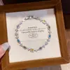 [Cadena de Diamantes Arcoíris] Pulsera de extracción de zircón trenzado en cruz, una pulsera lujosa y de alta gama, una pieza de joyería delicada y de moda