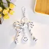 Estilo Ins Lazo Tejido a Mano Cordón de Nylon Nueva Moda Cara Sonriente Llavero Colgante para Mochila Escolar Femenina