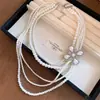 Colar multicamadas vintage europeu e americano com pérolas, diamantes, estrelas e flores, corrente de clavícula da moda para o dia a dia, acessório feminino versátil