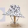 Sombrero de Pescador Transfronterizo para Mujer 2025 Nuevo Verano Protección Solar Estampado de Letras y Graffiti Correa Plegable al Aire Libre de Moda Sombrero Cubeta