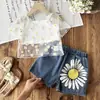 Conjunto de Tres Piezas para Niñas Primavera/Verano 2026 Europeo y Americano Transfronterizo: Blusa Hueca de Color Sólido + Camisola + Jeans con Estampado de Girasol