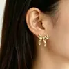Pendientes de lazo dorado transfronterizos europeos y americanos, elegantes y modernos, con un diseño de alta gama y único, hechos de metal