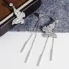 Pendientes de mariposa súper etéreos con una vibra genial y elegante de protagonista femenina, borlas de mariposa, pendientes para cara redonda, clips para orejas de disco de espiral de mosquito de lujo ligero únicos