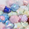 Una variedad de cuentas acrílicas con forma de corazón bañadas en color UV, con diseño de flores de amor y caramelo, accesorios de joyería para hacer tú mismo al por mayor