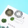 Accesorios de joyería al por mayor 26 mm reloj redondo marca retro DIY colgante hecho a mano accesorios de aleación